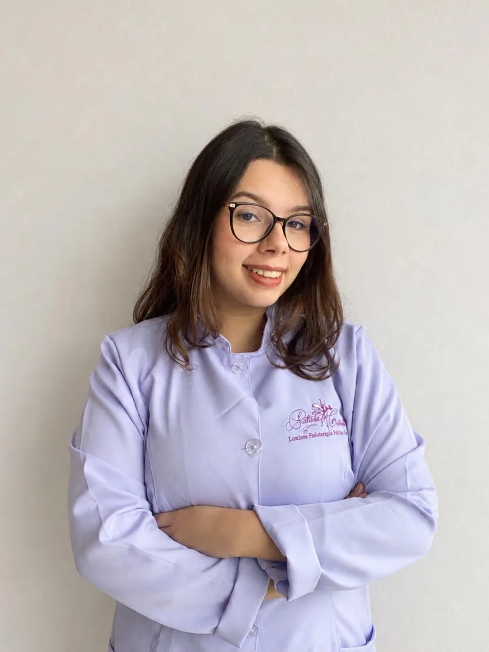 Aline Ferreira Gomes, fisioterapeuta e doula da Lumière, de jaleco lilás